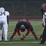 Juneau-Douglas senior Kana Galletes (51) prepares to long snap during high school football action this season.