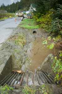 A culvert drain water at Wire Street and Greenwood Avenue after city crews cleared the area after a mudslide on Wednesday.