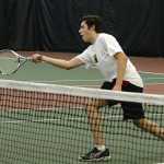 Juneau-Douglas High School senior Derek Dzinich returns a shot at the net during the Region V tennis tournament at the JRC/The Alaska Club Valley on Thursday. Play continues today from 11:30 a.m. to 2:30 p.m.