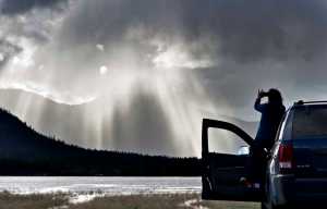 Felicitas Wehnes takes pictures of the dynamic rain showers over Douglas Island on Thursday. The National Weather Service calls for sunny on Friday with patchy fog in the morning. Highs around 51.
