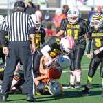 Wolverines' defenders Boom Schaa (23) and Kadin Messmer (22) bring down Gators runner Wallace Adams (32) during JYFL Junior Division playoff action on Saturday at Adair Kennedy Field. The Gators defeated the Wolverines 25-12 and will play the Bulldogs for the championship next Saturday at 11 a.m. on Adair. A slideshow of photos is online at juneauempire.com.