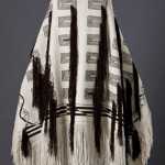This Ravenstail robe is the first all mountain robe in more than 200 years. The double helix along its side is for mountain goat DNA, and indicates how Baranof's goats are different.