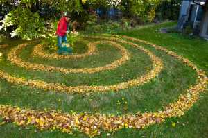 Juneau artist Jay Crondahl adds a little ephemeral art to the lawn at the Park Shore Condominiums on Monday.
