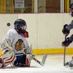 Floriane Wade makes a save during the ProHybrid Goalie Training camp at the Treadwell Ice Arena last week.