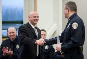 Daniel Darbonne, left, is congratulated by Juneau Police Chief Bryce Johnson after being sworn in as a new officer on Thursday.