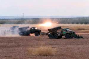In this photo taken on Wednesday, Syrian army rocket launchers fire near the village of Morek in Syria.