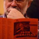 Virgil Fredenberg examines a program before a performance by singer-songwriter guitarist John Sebastian on Sunday, Oct. 11, at the Juneau Arts & Culture Center.