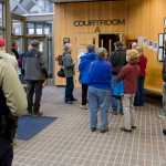 People interested in a civil lawsuit by trapper John Forrest against Kathleen Turley wait outside Juneau District Court Monday morning.
