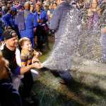 Chicago Cubs starting pitcher Jon Lester and his son Hudson spray champaign after the Cubs won 6-4 in Game 4 in baseball's National League Division Series against the St. Louis Cardinals, Tuesday, Oct. 13, 2015, in Chicago. (AP Photo/Charles Rex Arbogast)