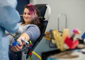 Mandee Smith, a junior at Thunder Mountain High School, watches as a technician takes a pint of her blood during a blood drive by the Blood Bank of Alaska at TMHS on Wednesday. The blood drive continues on Thursday at the University of Alaska Southeast from 9 a.m. to 3 p.m. and at Centennial Hall on Friday from 8 a.m. to 3 p.m.