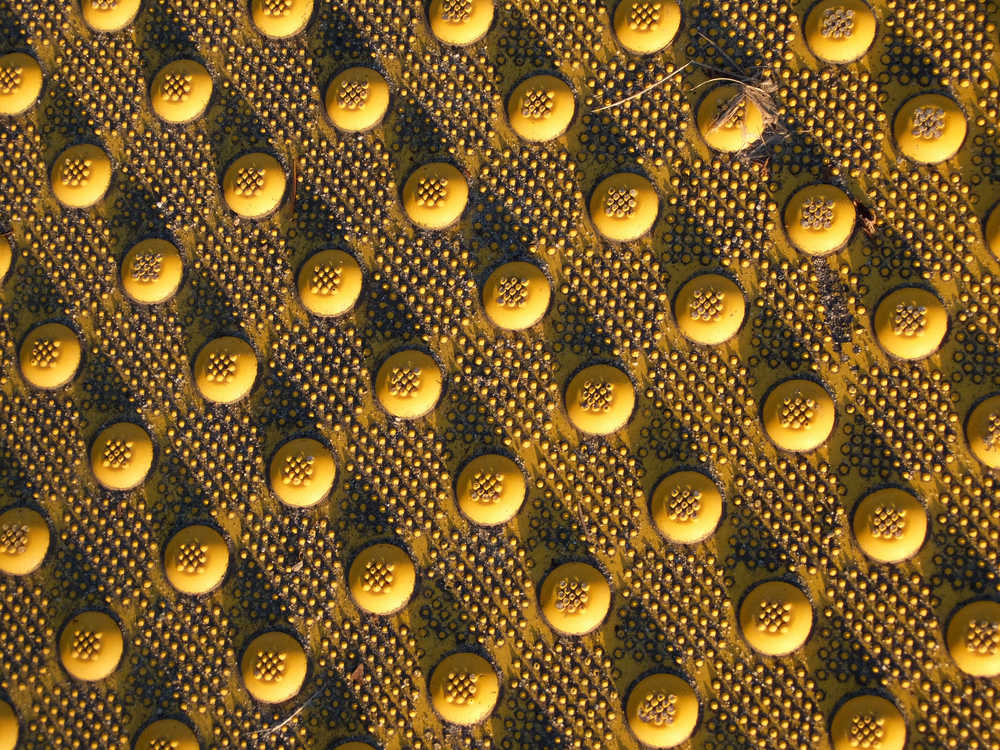 Sunset shadows on tactile paving.