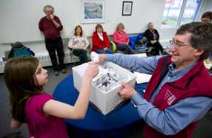 Madeline Germain, 10, helps Wayne Jensen draw a winning name during the Seward Statue raffle drawing at the Juneau Arts & Culture Center on Monday. The winners were Dennis Watson and Cindy Brady. Both won two tickets each to anywhere Alaska Airlines flies. About 150 people paid $100 per ticket to help pay to erect a life-size statue of William Henry Seward at the Dimond Courthouse Plaza.
