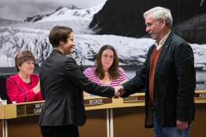 Greg Fisk shakes hands with City Attorney Amy Mead after she swore him into his Mayor seat on the Assembly Tuesday night.