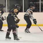 JDHS junior Cahal Morehouse, freshman Ronan Lynch and junior Simon Marks go jerseyless during Wednesday morning practice at Treadwell Arena.