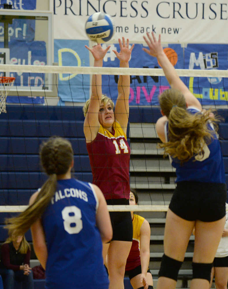 Mt. Edgecumbe's Madison Stumpf (14) attempts to block a spike by Thunder Mountain's Audrey Welling (9) during the All Comers Invitational at TMHS on Friday. Action resumes today and Saturday at Juneau-Douglas High School.