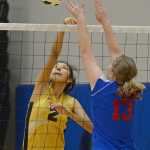 Mt. Edgecumbe's Sammantha Horner (2) tips a ball over Sitka's Payton Russell (13) during the All Comers Invitational at TMHS on Friday. Action resumes today and Saturday at Juneau-Douglas High School.