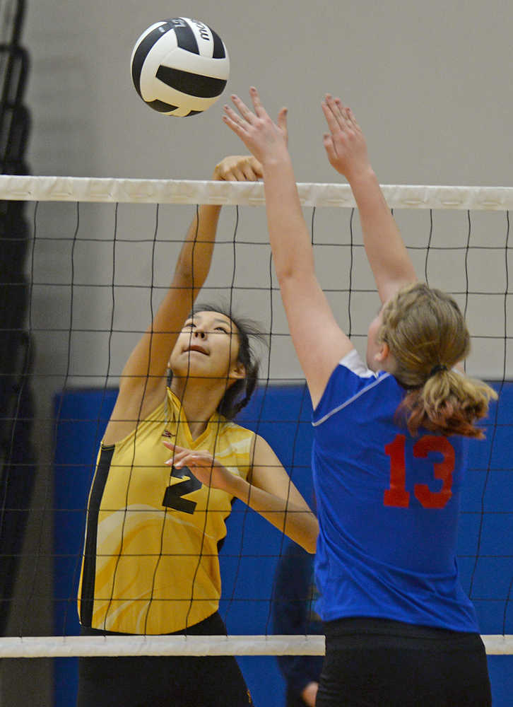 Mt. Edgecumbe's Sammantha Horner (2) tips a ball over Sitka's Payton Russell (13) during the All Comers Invitational at TMHS on Friday. Action resumes today and Saturday at Juneau-Douglas High School.