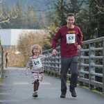 Marian Morrison, age 5, and father Aaron, 40, run hand-in-hand towards the Mendenhall River Trails during Juneau's 1st Annual PolioPlus Fun Run on Saturday at the Riverbend Elementary School covered playground. A slideshow of photos is online at Juneauempire.com.