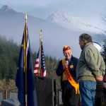 Alaska Native Brotherhood Grand President Sasha Soboleff recognizes Roy Peratrovich, Jr., as Marc Luiken, Commissioner of the Alaska Department of Transportation and Public Facilities, looks on during the Brotherhood Bridge rededication ceremony on Saturday. Peratrovich lead a design team for the first bridge in 1965 as well as sculpted the ten bronze medallions that decorate the old and current bridge.