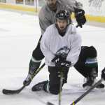 Liam Stewart, forefront, reaches for a puck during practice for the Alaska Aces hockey team in Anchorage. Stewart, the son of rock superstar Rod Stewart and supermodel Rachel Hunter, says he just wants to be treated as one of the guys.