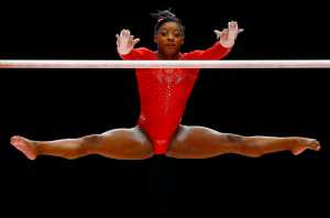 Simone Biles of the U.S. performs on the uneven bars during the women's all-around final competition at the World Artistic Gymnastics championships at the SSE Hydro Arena in Glasgow, Scotland, Thursday, Oct. 29, 2015. (AP Photo/Matthias Schrader)