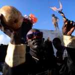 A voodoo believer participates in a ritual that pays tribute to Baron Samdi and the Gede family of spirits during Day of the Dead celebrations Sunday at the National Cemetery in Port-au-Prince, Haiti.
