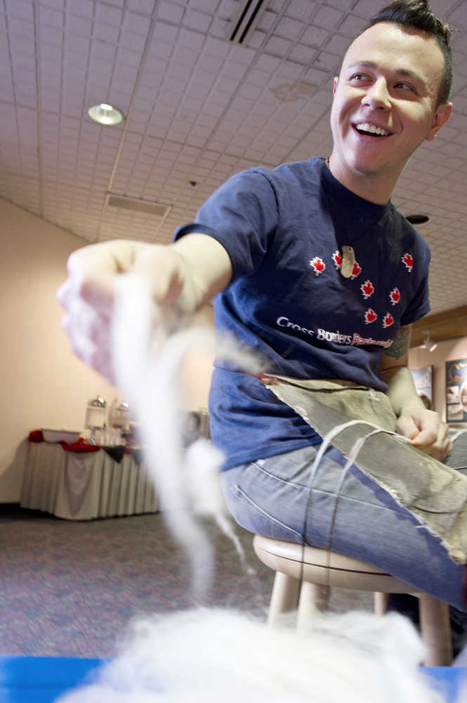 Ricky Tagaban prepares a warp of red cedar bark and merino wool for a future Chilkat weaving during a weavers exhibit in the lobby of Centennial Hall on Thursday during  "Sharing Our Knowledge," a three-day conference of Tlingit tribes and clans, that ran Oct. 28-Nov. 1.