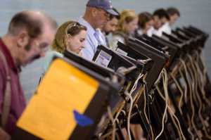 Voters use electronic voting machines at the Schiller Recreation Center polling station on election day, Tuesday, Nov. 3, 2015, in Columbus, Ohio. Eligible Ohioans headed to the polls Tuesday, to decide whether to make marijuana legal for both recreational and medical use. (AP Photo/John Minchillo)