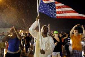In this Aug. 9 photo, protesters march to mark the one-year anniversary of Michael Brown being shot and killed by Ferguson Police Officer Darren Wilson.