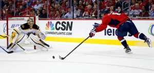 Washington Capitals left wing Alex Ovechkin, right, from Russia, reaches for the puck as Boston Bruins goalie Tuukka Rask (40), from Finland watches during the first period of an NHL hockey game, Thursday, Nov. 5, 2015, in Washington. (AP Photo/Alex Brandon)