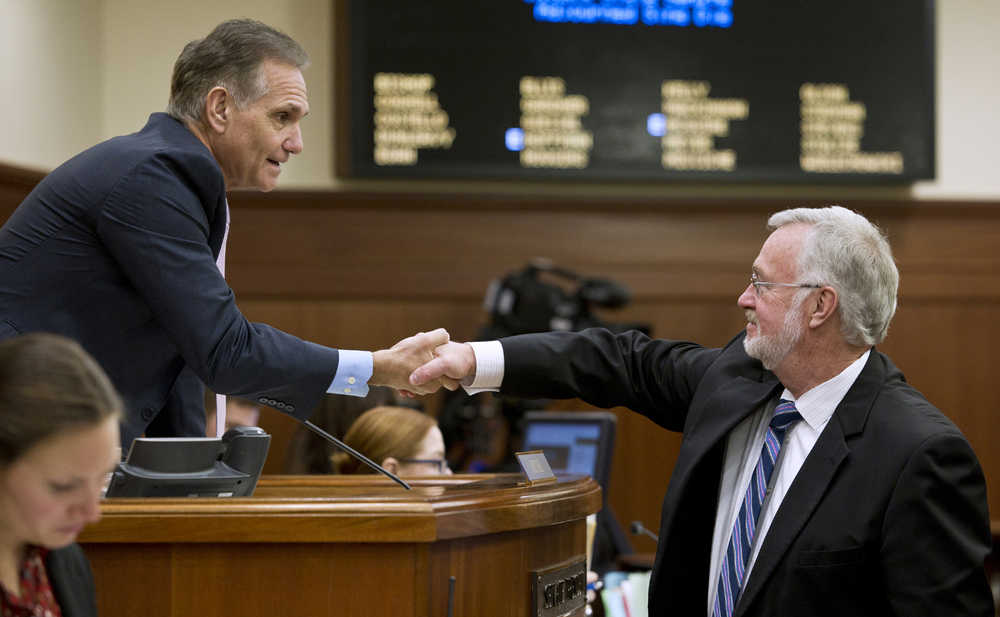 Senate President Kevin Meyer, R-Anchorage, left, shakes hands with Sen. Gary Stevens, R-Kodiak, after Meyer gaveled out of the third special session of the 29th Legislature on Thursday.