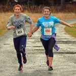 Top female finishers Naomi Welling, age 17, and Erin Wallace, age 14, finish in a tie at Saturday's Veterans Day Run. A slideshow of photos is at juneauempire.com.