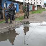 Burundian police and soldiers guard a deserted street on Sunday in Bujumbura, Burundi.