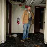 James Barrett, owner of the Gastineau Apartments, looks at damage in the third floor hallway of the Franklin Street building two days after a major fire on November 5, 2013.