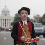 Will Kirkland plays the drums while marching with the Sons of the American Revolution in a Veteran's Day parade on Wednesday in Montgomery, Alabama.
