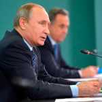 Russian President Vladimir Putin, left, and Sports Minister Vitaly Mutko, attend their late-night meeting with the heads of Russia's sports federations in the Black Sea resort of Sochi, Russia, on Wednesday. Putin has ordered an investigation into allegations of widespread doping among the country's sports figures. (Alexei Druzhinin | RIA-Novosti,  Kremlin Pool Photo via AP)