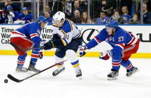 New York Rangers defenseman Ryan McDonagh (27) steals the puck from St. Louis Blues right wing Vladimir Tarasenko (91), of Russia, as Rangers center J.T. Miller (10) looks on in the third period of an NHL hockey game in New York, Thursday, Nov. 12, 2015. The Rangers defeated the Blues 6-3. (AP Photo/Kathy Willens)