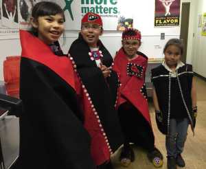 Performers in the Angoon lunchroom wait for their entrance before going on stage Thursday. The students wrote their own play "Raven Stole the Sun," based on the traditional Tlingit story, with the help of Gustavus artist Sarah Campen.