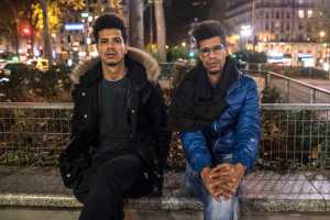 In this photo taken on Sunday, Khaled Saadi, 27, left and Abdullah Saadi, 38, listen during an interview with the Associated Press.