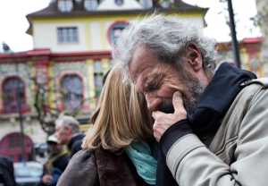 Jean-Marie de Peretti mourns the loss of his 33-year-old daughter Aurelie, one of the victims of the attack on  the Bataclan concert hall, rear, Tuesday in Paris.
