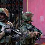 French soldiers take up position in Paris suburb Saint-Denis, Wednesday, Nov. 18, 2015. Explosions and gunfire rang out early Wednesday as heavily armed police surrounded a suburban Paris apartment in a raid targeting the suspected mastermind of last week's Paris attacks. At least two people were killed and two arrested. (AP Photo/Peter Dejong)