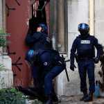 French police officers storm a church after a raid in Paris suburb Saint-Denis, Wednesday, Nov.18, 2015.  A woman wearing an explosive suicide vest blew herself up Wednesday as heavily armed police tried to storm a suburban Paris apartment where the suspected mastermind of last week's attacks was believed to be holed up, police said. (AP Photo/Thibault Camus)