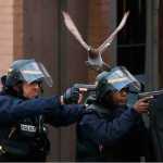 Police forces operate in Saint-Denis, a northern suburb of Paris, Wednesday, Nov. 18, 2015. Police say two suspects in last week's Paris attacks, a man and a woman, have been killed in a police operation north of the capital. Two police officers have been injured in the standoff. Police have said the operation is targeting the suspected mastermind of last week's attacks, believed to be holed up in an apartment in Saint-Denis with several other heavily armed suspects. (AP Photo/Francois Mori)