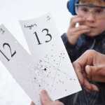 Logan Miller, 12, bites his fingernails as he awaits the result of his attempt in the card shoot event on Saturday, Nov. 21, 2015. This event, part of the 2015 Turkey Shoot, invites participants to fire shotguns at stationary targets. The person whose shot is closest to the center of an X marked on the card wins a frozen turkey.