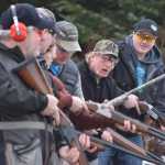 Wayne Wilson looks down the firing line at the next shooters after advancing to the next round in the Annie Oakley competition Saturday, Nov. 21, 2015 at the Juneau Gun Club's Turkey Shoot. Eric Verrelli, at back, won the initial competition, taking home a frozen turkey.