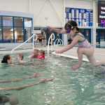 Fiona McFalin, 4, jumps to her father, Dale, as they swim at the Dimond Park Aquatic Center on Thursday, Nov. 5.