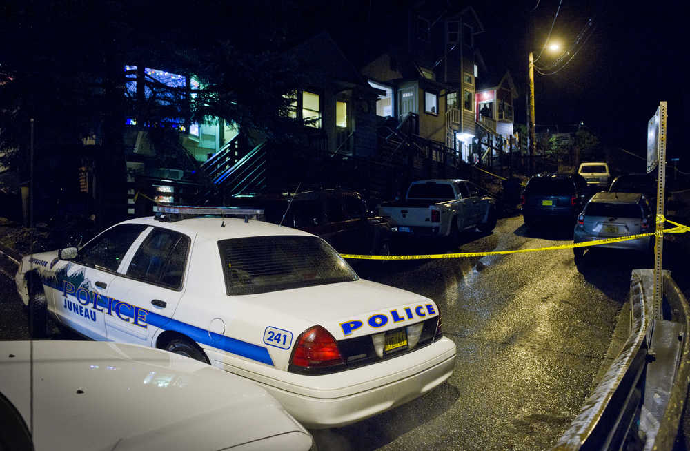 Police tape stretches across Kennedy Street Monday evening.