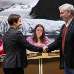 Greg Fisk shakes hands with City Attorney Amy Mead after she swore him in as Mayor before the Assembly on Oct. 20.