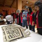 People attending a public ceremony Tuesday at the Walter Soboleff Center get a close up view of a Chilkat robe recently acquired on eBay by the Sealaska Heritage Institute.