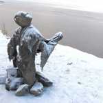 Sculptures made of straw, cement, plaster and burlap that were damaged by incoming tides last week were being repositioned Friday, Dec. 4, 2015, at the site of a public art installation in Anchorage, Alaska. Creators of the display plan to have the exhibit ready by Saturday for its official opening. Participants say the 100Stone project represents people dealing with emotional vulnerabilities, including trauma and mental illness. (AP Photo/Rachel D'Oro)